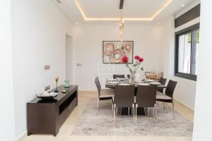 a dining room with a table and chairs at Luxury Villa with Private Pool STR1 in Tangier