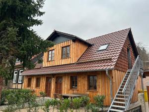 a large wooden house with a metal roof at Insel 8 in Wernigerode