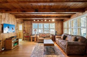 a living room with a couch and a table at 3BR Mountain Cabin-Near Beach & Slopes in Homewood +18 photos