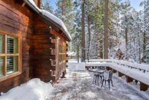 a cabin in the snow with a table and chairs at 3BR Mountain Cabin-Near Beach & Slopes in Homewood