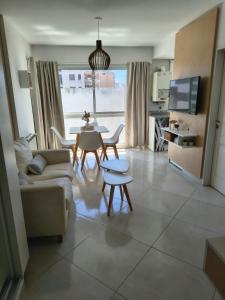 a living room with a couch and a table at Una perla a metros del mar in Mar del Plata +9 photos