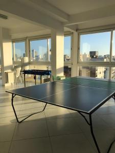 a ping pong table in the middle of a room at Una perla a metros del mar in Mar del Plata