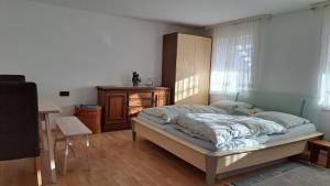 a bedroom with a bed and a dresser and a window at Retrowohnung in Oberndorf in Oberndorf
