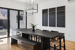 a dining room with a black table and chairs at Modern Luxury at Copper View Moab in Moab