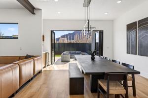 a dining room with a table and a couch at Modern Luxury at Copper View Moab in Moab