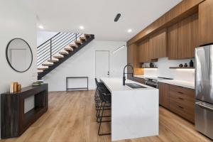 a kitchen with wooden cabinets and a staircase at New Modern Luxury at Copper View Moab in Moab