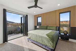 a bedroom with a bed and a large window at New Modern Luxury at Copper View Moab in Moab