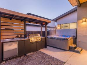an outdoor kitchen with a grill and a grill at New Modern Luxury at Copper View Moab in Moab +25 photos