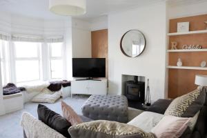 a living room with a couch and a tv at Sandy Feet Retreat in Exmouth