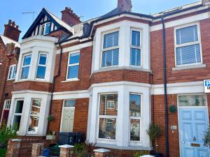 a red brick house with a white door at Sandy Feet Retreat in Exmouth