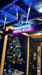 a christmas tree in front of a karma house at Traditional Narva House in Narva +32 photos