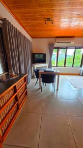 a living room with a table and a desk at Rosies on Robin - Pool, Braai & Mountain Views in Rustenburg