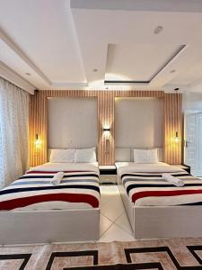 two beds in a hotel room with two bedsvisor at LuX EXECUTIVE 2 BEDROOM in Eldoret