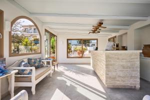 a living room with a couch and a table at Spiros-Soula Thematic Suites in Agia Pelagia