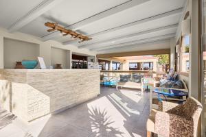 a resort lobby with a bar and chairs at Spiros-Soula Thematic Suites in Agia Pelagia