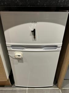 a white refrigerator freezer sitting in a kitchen at The Grove En-Suite Rooms in Bristol