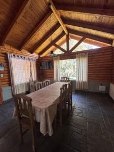 a large dining room with a table and chairs at Cabañas EL CAMPITO in Aluminé +2 photos