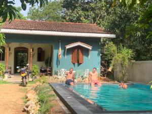 a group of people in a swimming pool in a house at Owl's Nest Chalet in Udawalawe