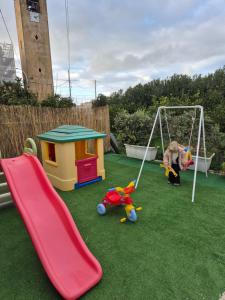a playground with a slide and a swing at A un Passo dal Tramonto in Marsala