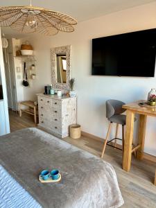 a bedroom with a large flat screen tv on the wall at Studios Nuitée en Provence in Aix-en-Provence