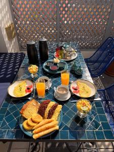 a table topped with plates of breakfast foods and drinks at Riad Blue Berry & SPA in Marrakesh +77 photos