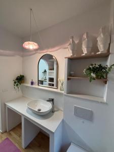 a bathroom with a white sink and a mirror at L'Intermezzo in Venzone +67 photos