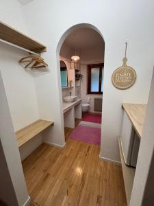 a hallway with a bathroom with a sink and a toilet at L'Intermezzo in Venzone