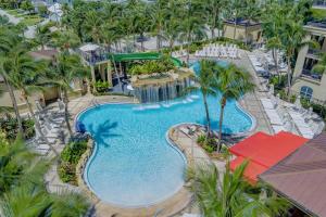 an overhead view of a swimming pool at a resort at 2B Beachfront condo! Pool! Games! 15 mins to PBI! in Riviera Beach