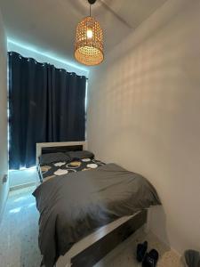 a bedroom with a bed and a chandelier at Private Room Late checkout 2pm in Abu Dhabi
