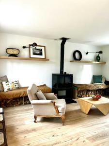 a living room with a couch and a fireplace at Charming House In Lyons-La-Forêt in Lyons-la-Forêt