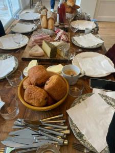 a table with a plate of bread and cheese at Charming House In Lyons-La-Forêt in Lyons-la-Forêt