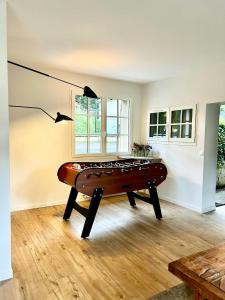a pool table in a living room with a lamp at Charming House In Lyons-La-Forêt in Lyons-la-Forêt