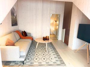 a living room with a couch and a table at Alpine Townhouse - Åre Valley Lodges in Åre