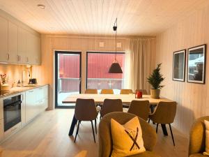 a kitchen and dining room with a table and chairs at Alpine Townhouse - Åre Valley Lodges in Åre