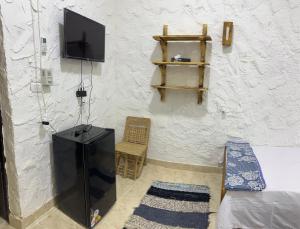 a room with a tv and a couch and a chair at لودج ادرار احكيك in Siwa