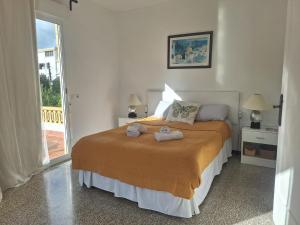 a bedroom with a bed with two towels on it at Villa Nevada - Espacioso Chalet con Piscina Privada y Salita de Cine in Port de Pollensa +31 photos