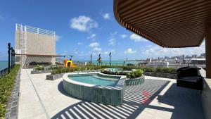 a swimming pool with a slide and a playground at Flat Beira Mar 331 - 424 - 426 in João Pessoa