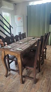 a large wooden table with chairs around it at Casa de la Sierras in Cerro de Oro