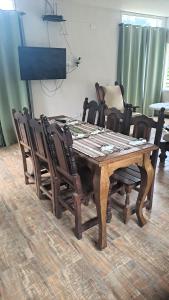 a dining room table with chairs around it at Casa de la Sierras in Cerro de Oro