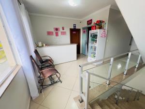 a kitchen with a refrigerator and a table and chairs at Pousada residencial in Curvelo