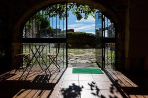 an entrance to a building with an open door at Alberg La Solana in Salás de Pallás