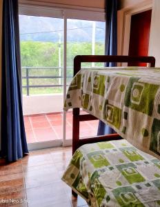 a bedroom with a bed and a window with a view at Casa de la Sierras in Cerro de Oro