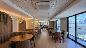 a restaurant with tables and chairs and a large window at Flat Beira Mar 331 - 424 - 426 in João Pessoa