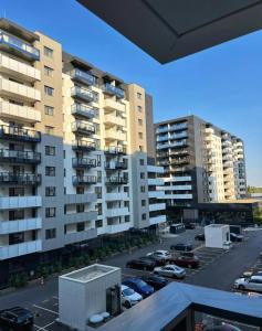 a view of a parking lot with tall buildings at Cortina - Yard & Wellness View in Voluntari