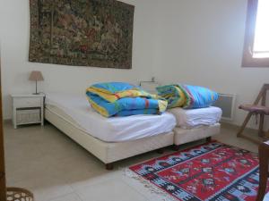a bed with two pillows on it in a room at Les Allobroges C03 in Guillestre