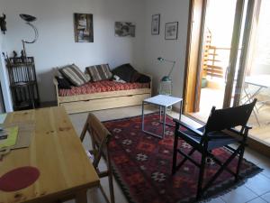 a living room with a couch and a table at Les Allobroges C03 in Guillestre