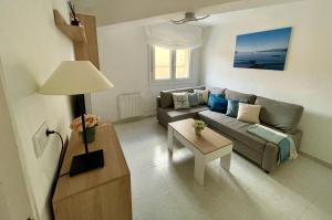 a living room with a couch and a table at El Orbayín de Llastres in Lastres