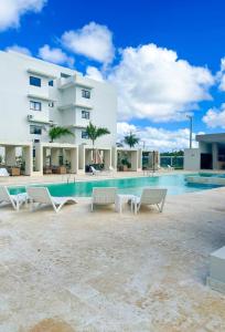 a resort with a swimming pool and a building at Epic Punta Cana in Punta Cana