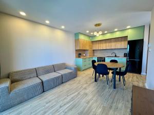 a living room with a couch and a table and chairs at Apartament Kwiatowa in Tychy +3 photos