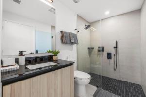 a bathroom with a sink and a toilet and a shower at Downtown Miami - Rooftop Pool & Gym in Miami